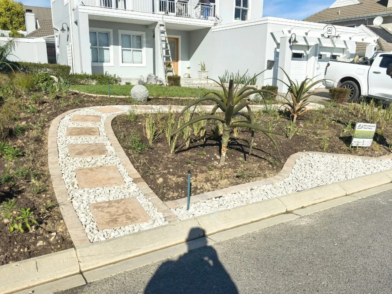 Decorative stone garden with a curved paver path