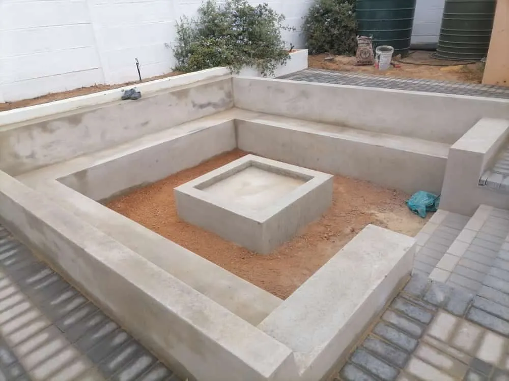 Sunken seating area with square fire pit under construction