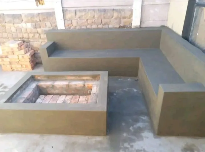 Plastered L-shaped bench with brick fire pit