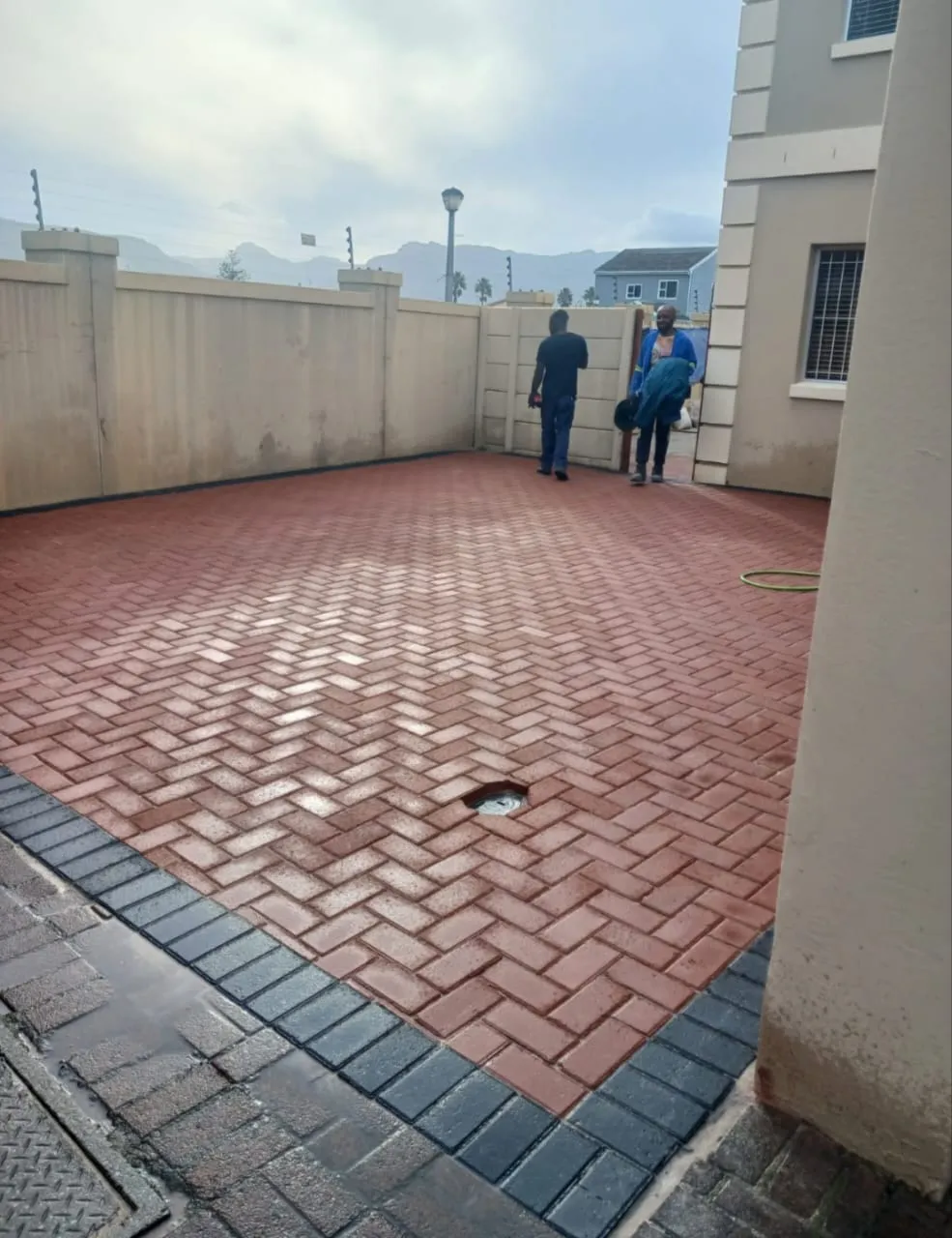 Red brick paved yard with charcoal border